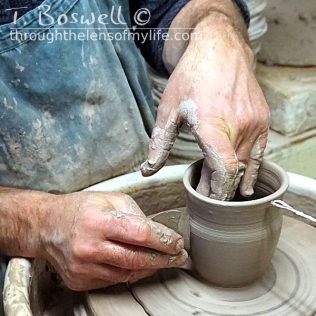 Smoothing the pot with a metal rib.